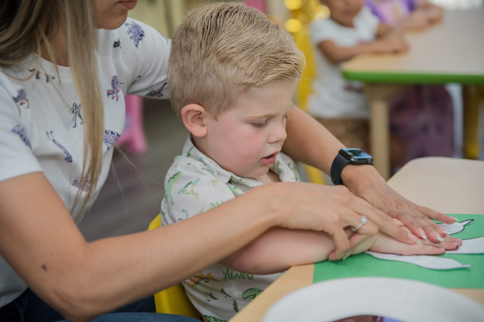 A teacher giving one-on-one attention to a child at MyPlace in Katy, TX